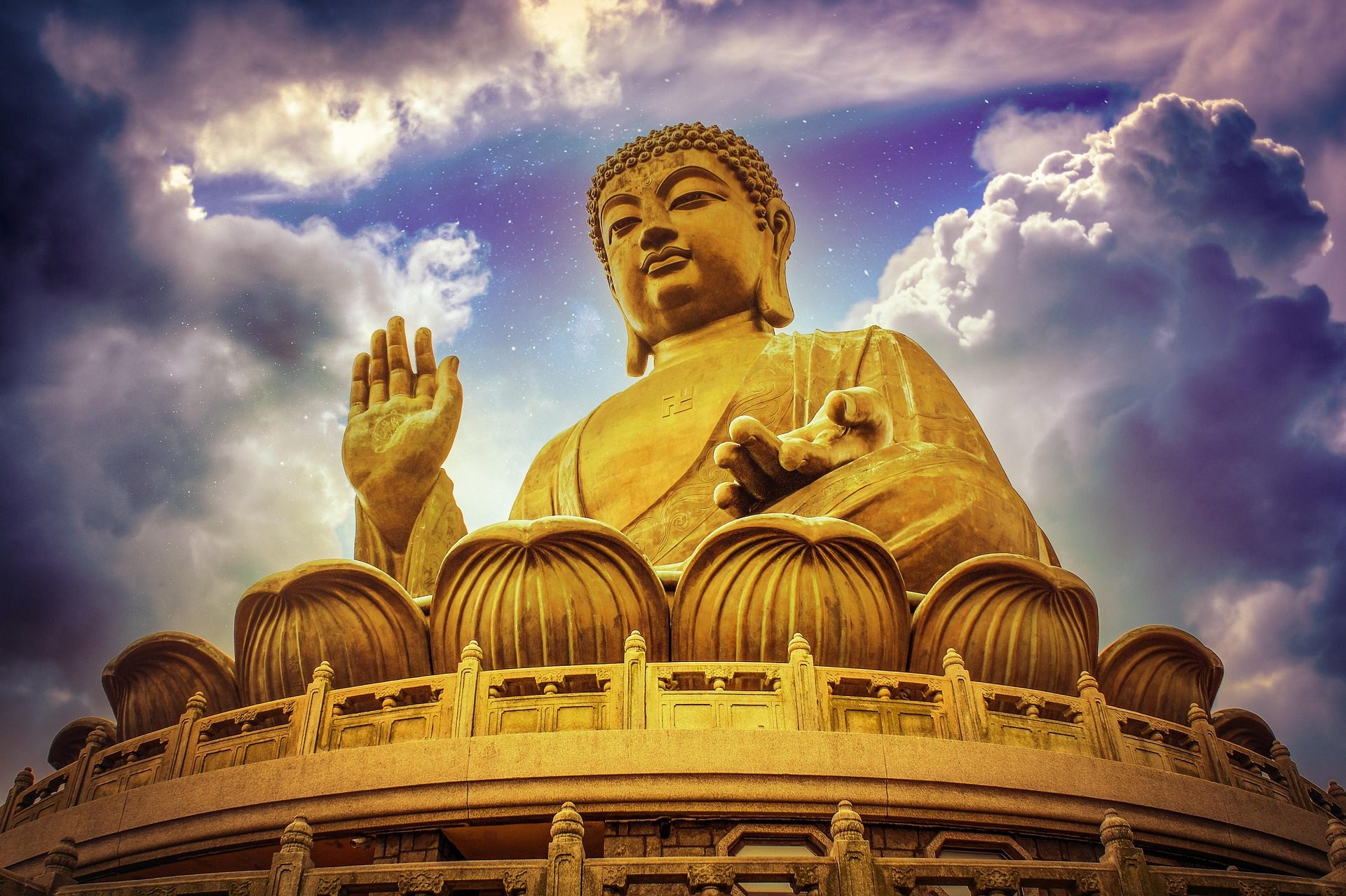 Tian Tan Big Buddha bronze statue against dramatic sky