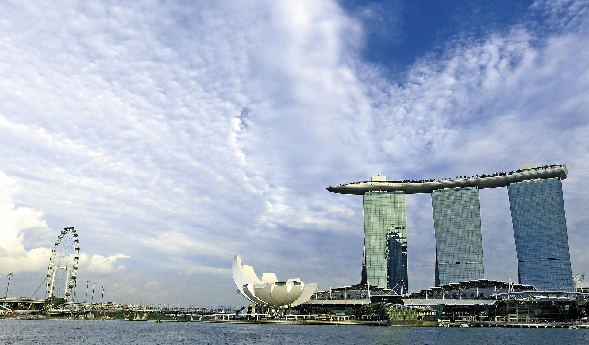 Marina Bay Sands illuminated at blue hour with reflections